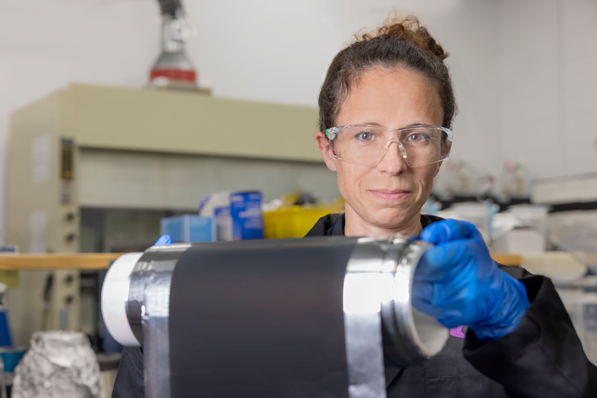 Miltec chemist holding a roll of lithium-ion cathode. Photo by Gary Landsman.